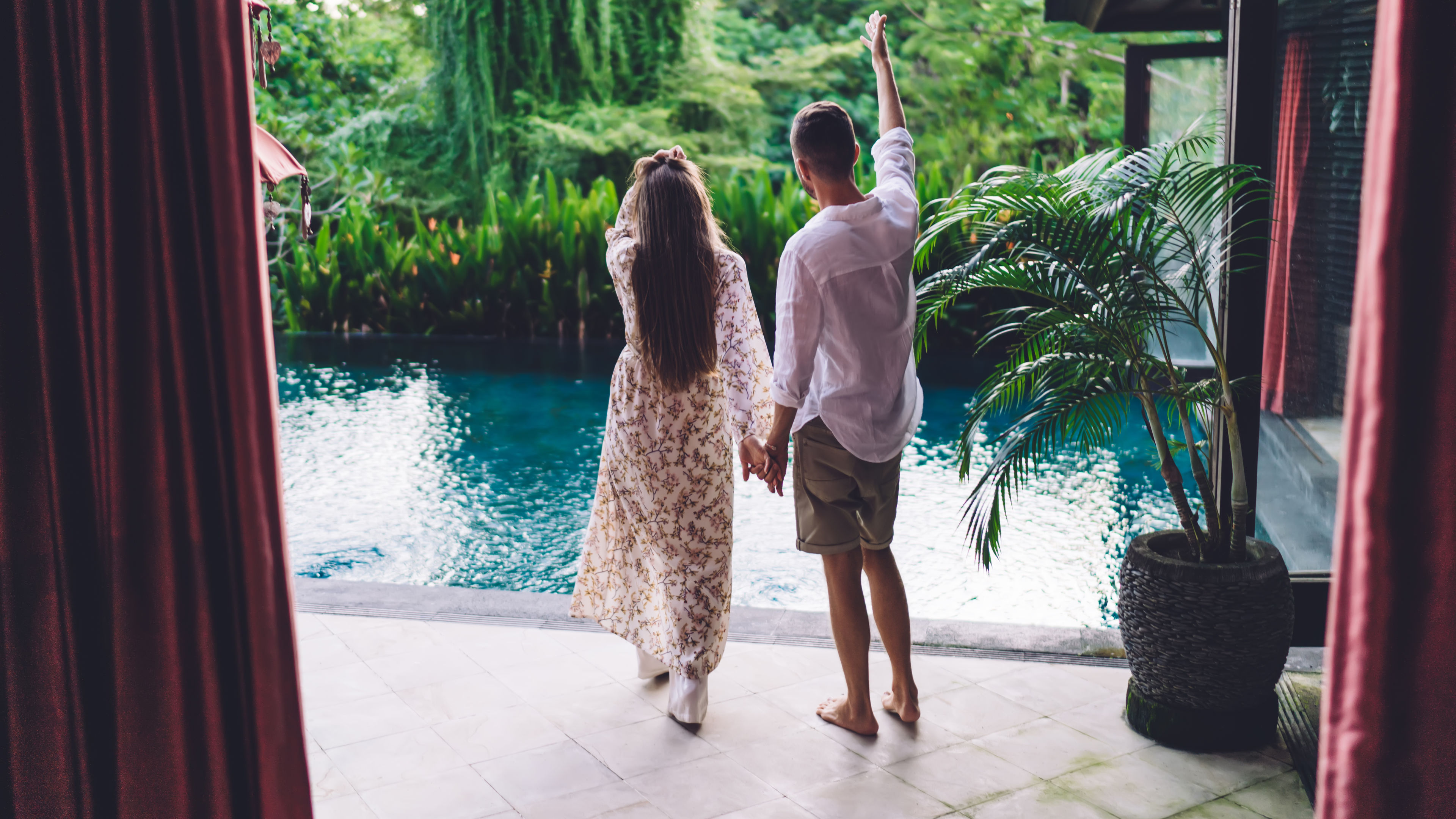 couple holding hands and enjoying a tropical resort