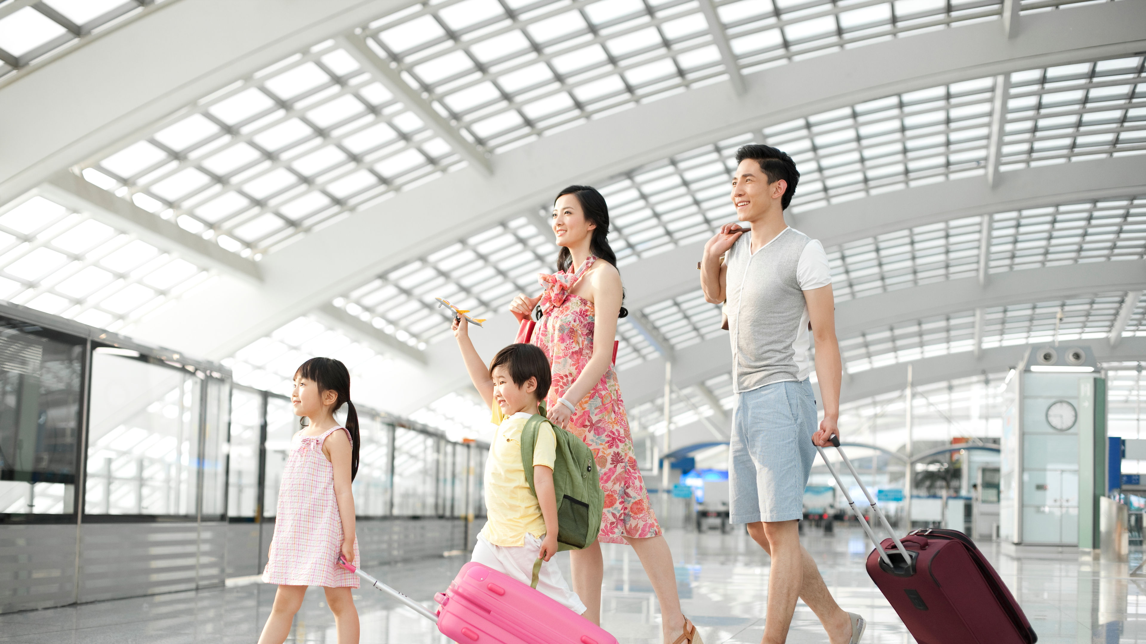 Happy young family leaving with luggage